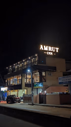 Amrut Inn Murudeshwar - Clean budget hotel near bus stand with illuminated signage