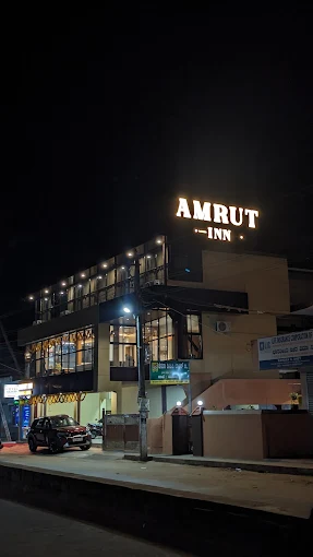 Amrut Inn Murudeshwar - Clean budget hotel near bus stand with illuminated signage