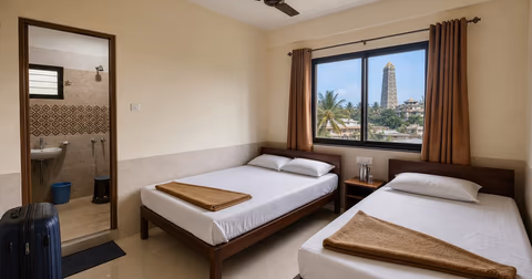 Clean budget hotel room in Murudeshwar with basic beds and attached bathroom
