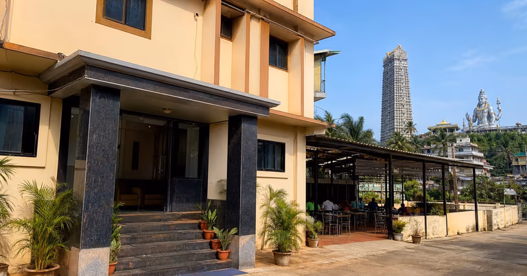 Budget hotel entrance near Murudeshwar Temple with simple dining area